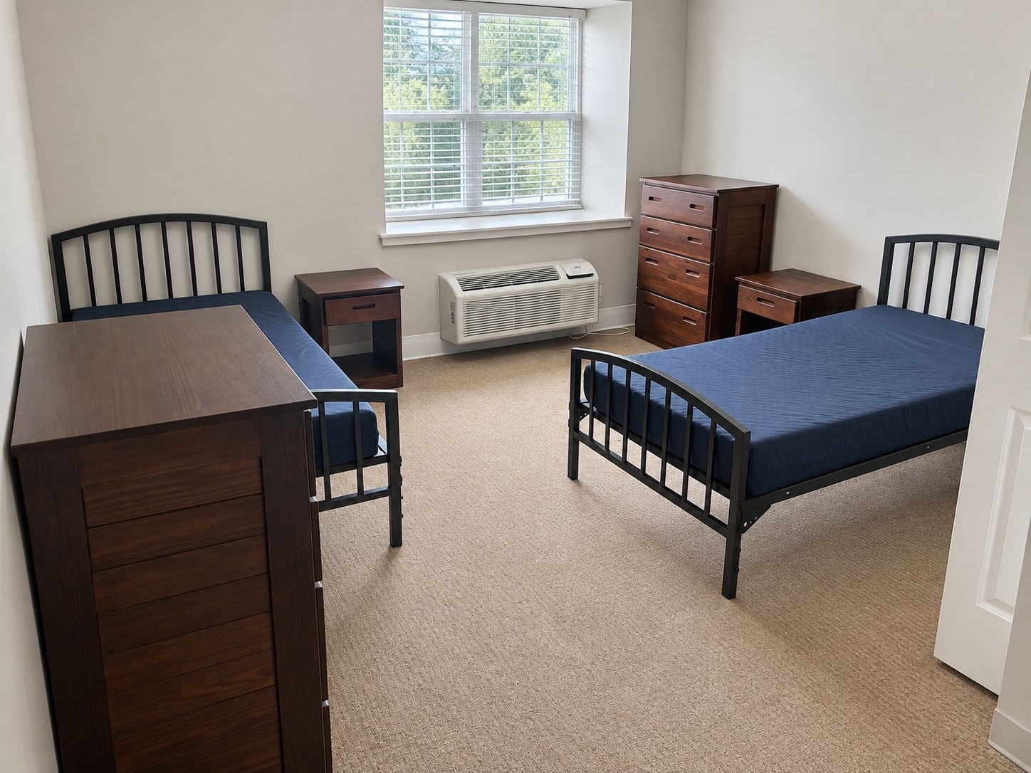 A two-bed resident room at Oak Grove Recovery in Westerville, Ohio, with a window overlooking the grounds