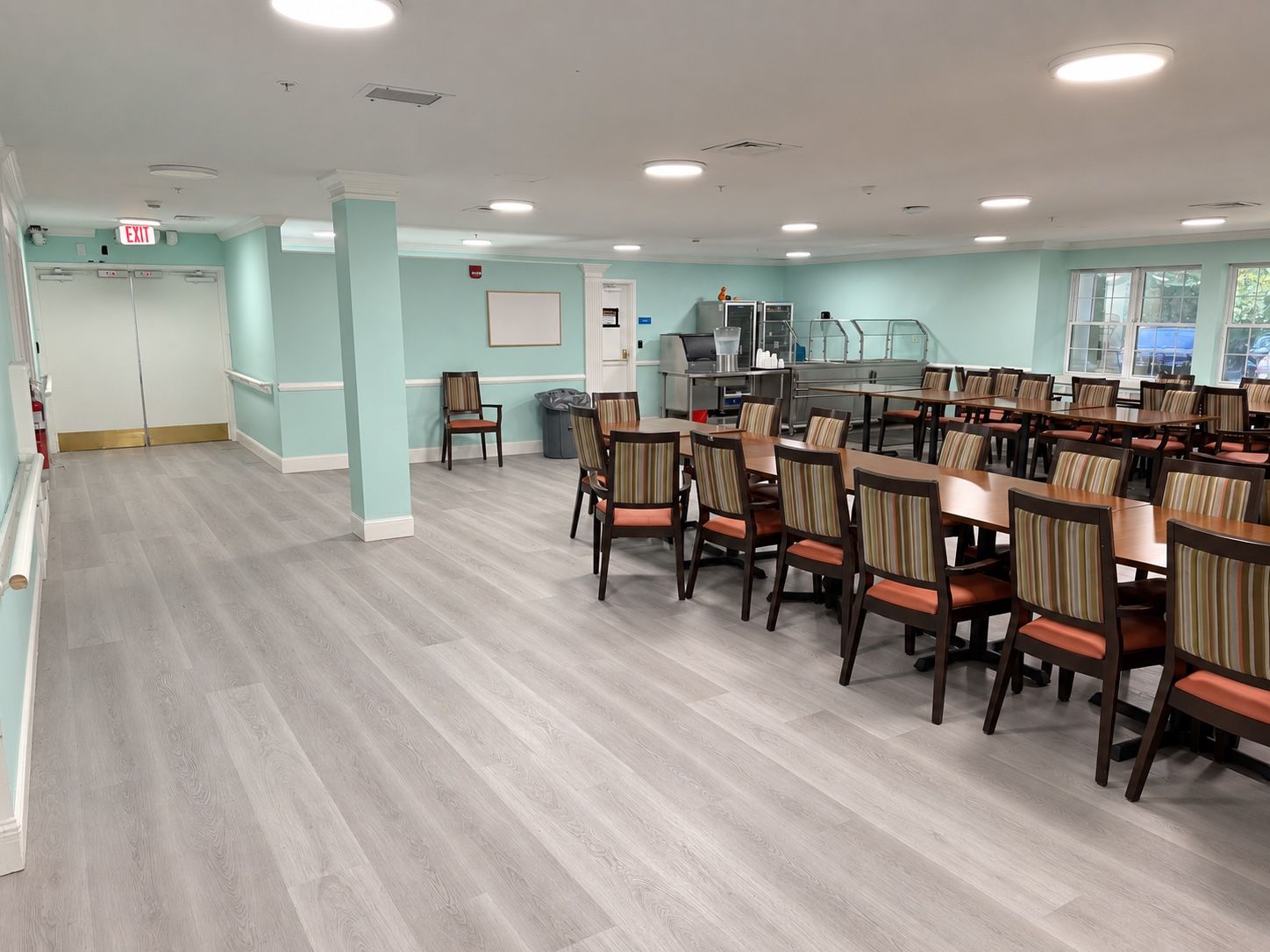 The dining room at Oak Grove Recovery in Westerville, Ohio, with tables, chairs and a serving counter