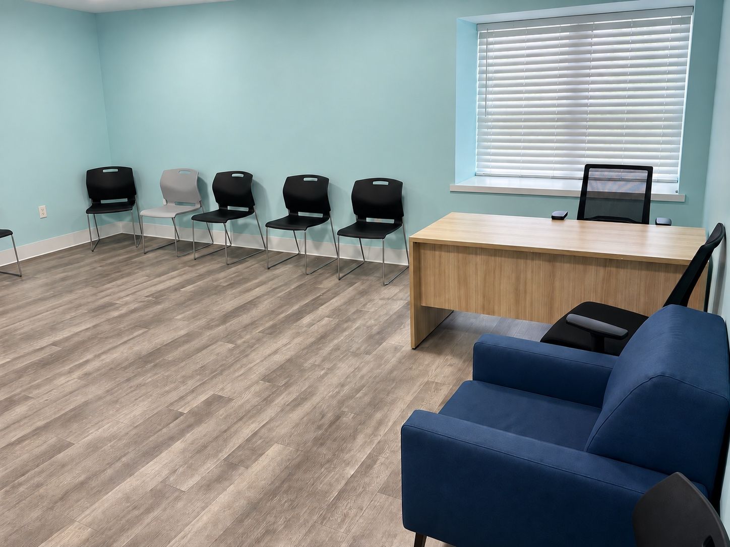 An office at Oak Grove Recovery in Westerville, Ohio, with a desk, a couch and a row of chairs