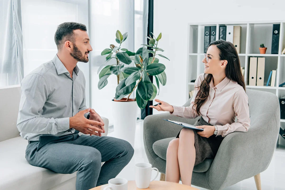 Man and woman sitting in therapy session