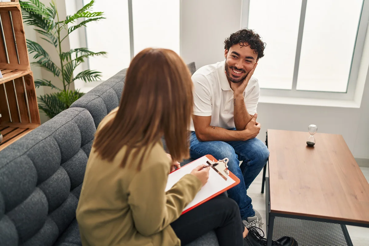 Man speaking to counselor on couch
