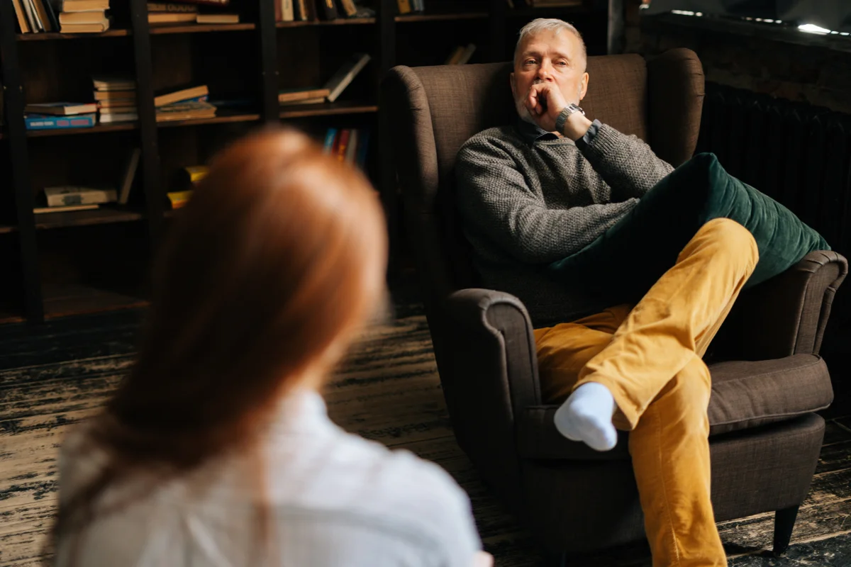 Pensive man sitting in chair