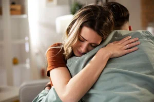 Blond wife hugging distraught husband